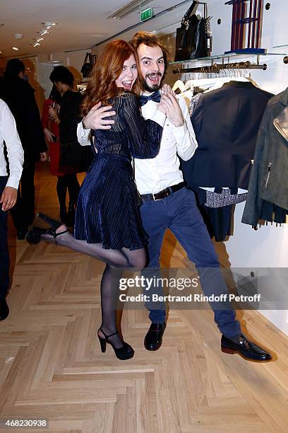 Actress Lou Lesage dancing with a waiter attend the Tommy Hilfiger Boutique Opening at Boulevard Capucines on March 31, 2015 in Paris, France.