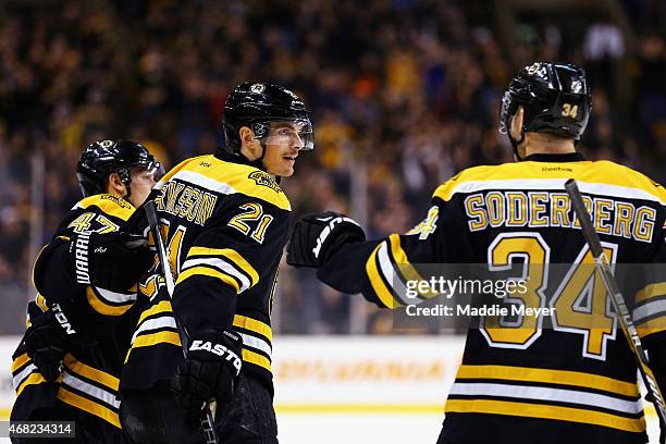 Carl Soderberg congratulates Loui Eriksson of the Boston Bruins after he scored a goal against the Florida Panthers during the first period at TD...