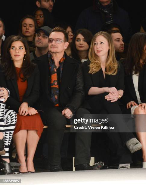 America Ferrera, Bono and Chelsea Clinton front row at Edun - Mercedes-Benz Fashion Week Fall 2014 at Skylight Modern on February 9, 2014 in New York...