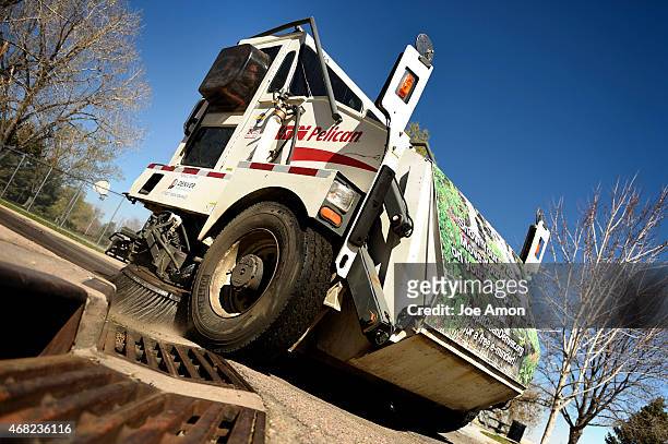 March 31, 2015: Equipment operator specialist Pat Sanchez hangs tight to the curb as a reminder Denver's annual street sweeping program begins April...