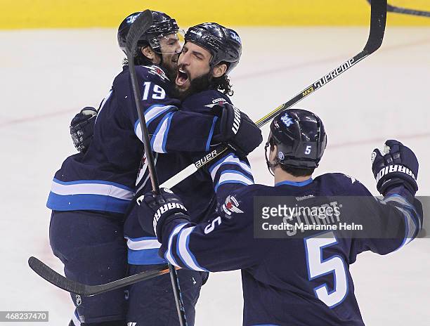 Chris Thorburn of the Winnipeg Jets congratulates teammate Jim Slater for his goal in first period action in an NHL game against the New York Rangers...