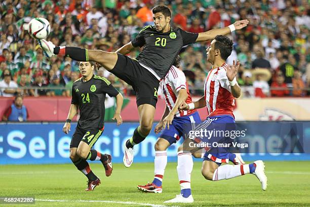 Eduardo Herrera of Mexico shoots to score the first goal of his team during an international friendly match between Paraguay and Mexico at Arrowhead...