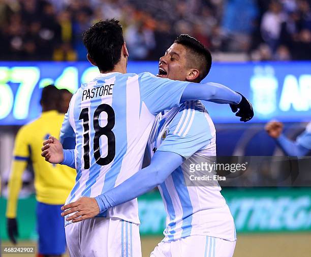 Javier Pastore of Argentina is congratulated by teammate Marcos Rojo after Pastore scored a goal in the second half against Equador during a friendly...