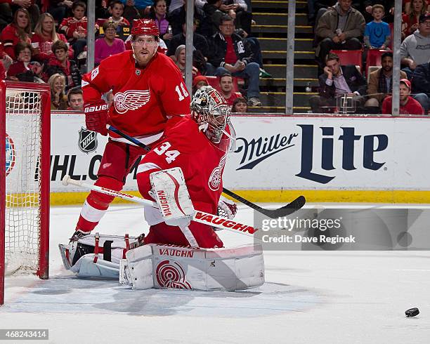 Goalie Petr Mrazek of the Detroit Red Wings looks to make a save while teammate Joakim Andersson follows the play during a NHL game against the...