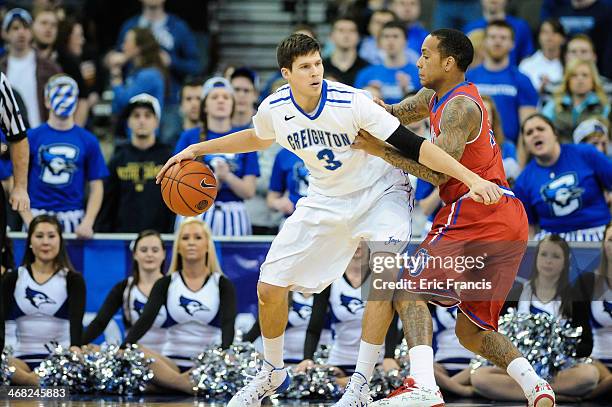 Angelo Harrison of the St. John's Red Storm guards Doug McDermott of the Creighton Bluejays during their game at CenturyLink Center on January 28,...