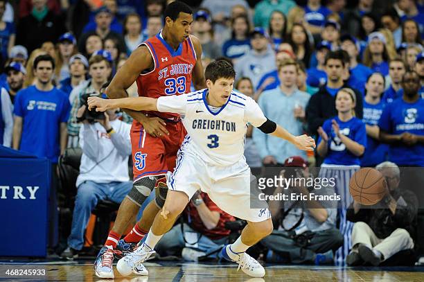Doug McDermott of the Creighton Bluejays and Orlando Sanchez of the St. John's Red Storm eye a loose ball during their game at CenturyLink Center on...