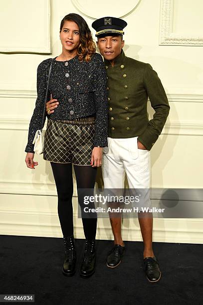 Pharrell Williams and Helen Lasichanh attends the CHANEL Paris-Salzburg 2014/15 Metiers d'Art Collection in New York City at the Park Avenue Armory...