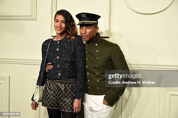 Pharrell Williams and Helen Lasichanh attends the CHANEL Paris-Salzburg 2014/15 Metiers d'Art Collection in New York City at the Park Avenue Armory...