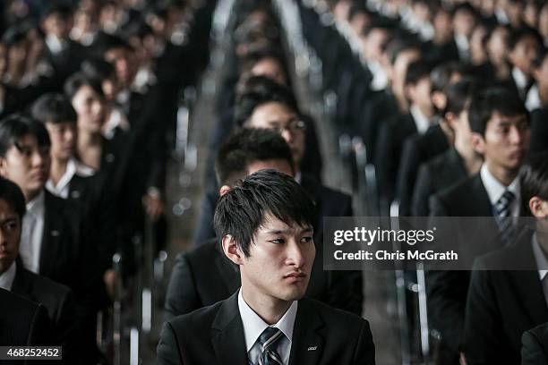New recruits listen to speeches during the welcome ceremony for new employees of All Nippon Airways Holdings at ANA hanger on April 1, 2015 in Tokyo,...