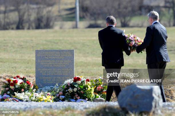 Lufthansa CEO Carsten Spohr and Germanwings CEO Thomas Winkelmann lay a wreath near a stele in memory of the victims of the Germanwings Airbus A320...