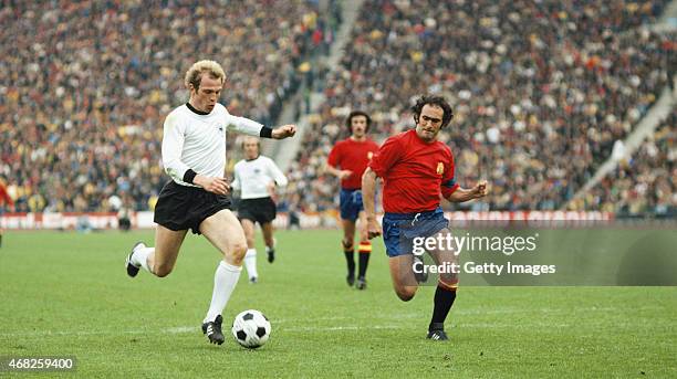 West Germany striker Uli Hoeness outpaces Jose Martinez Pirri of Spain during the 1976 UEFA European Championships Quarter Final between West Germany...
