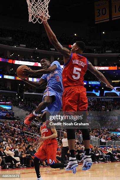 Darren Collison of the Los Angeles Clippers shoots against Arnett Moultrie of the Philadelphia 76ers at STAPLES Center on February 9, 2014 in Los...