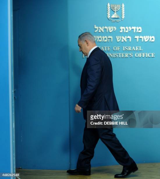 Israeli Prime Minister Benjamin Netanyahu leaves after making a statement to the press about negotiations with Iran at his office in Jerusalem on...