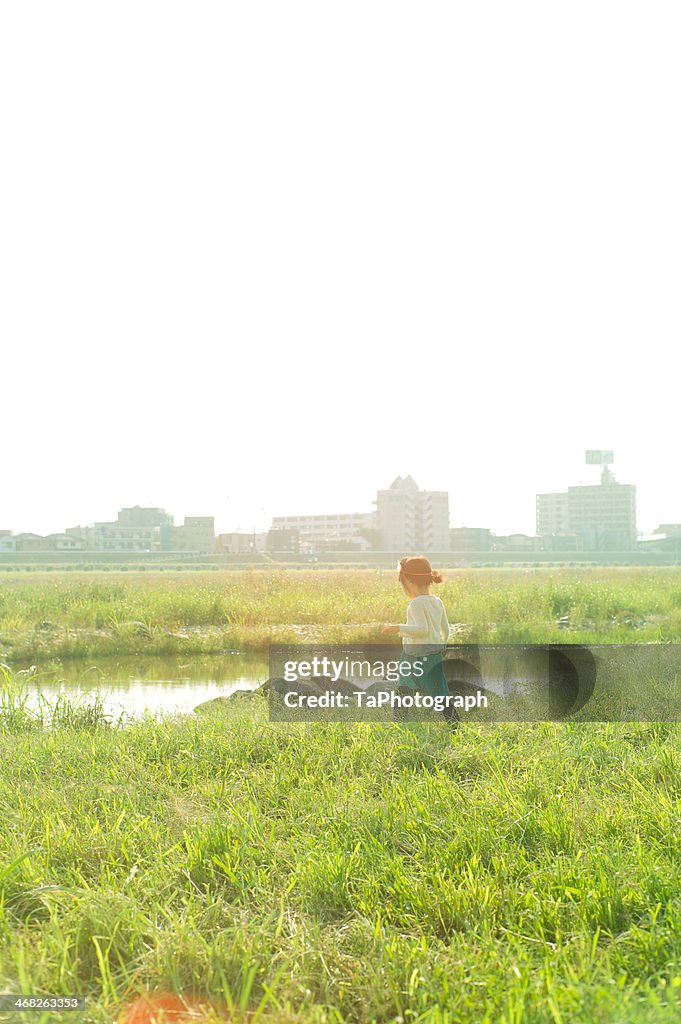 Girl walking along the river