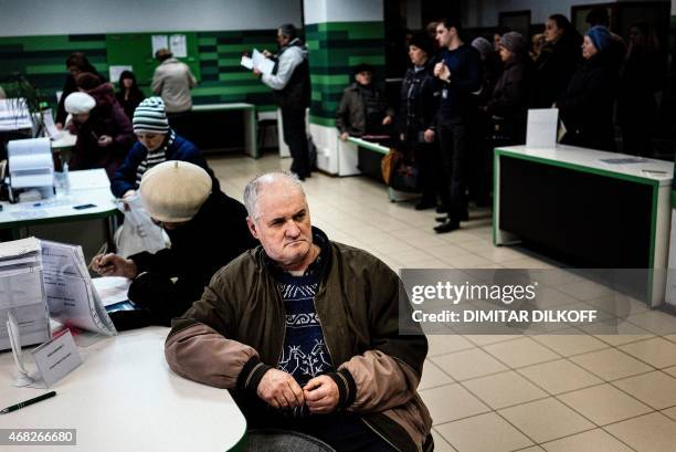 Man waits to receive his pension paid in Russian ruble notes in the eastern Ukrainian city of Donetsk on April 1, 2015. The year-long conflict in...