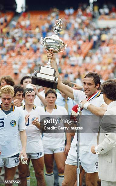 New York Cosmos captain Giorgio Chinaglia holds aloft the trophy after the 1980 Soccer Bowl victory against the Fort Lauderdale Strikers at RFK...