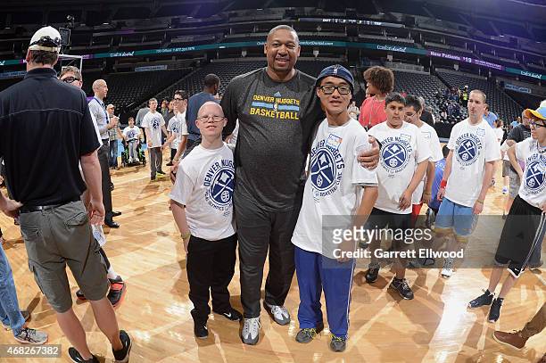 Head Coach Melvin Hunt of the Denver Nuggets takes a photo with participants during a basketball clinic for Special Olympics athletes from Colorado...