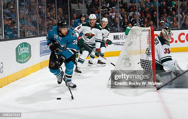 Bracken Kearns of the San Jose Sharks skates with the puck against the Minnesota Wild at SAP Center on January 25, 2014 in San Jose, California.