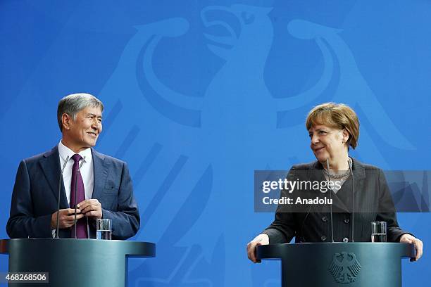 Kyrgyzstan's President Almazbek Atambayev delivers a speech during a joint press conference with German Chancellor Angela Merkel at the German...