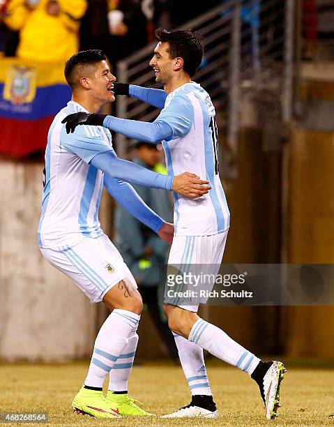 Javier Pastore of Argentina celebrates with Marcos Rojo after scoring his team's second goal during an international friendly match between Argentina...