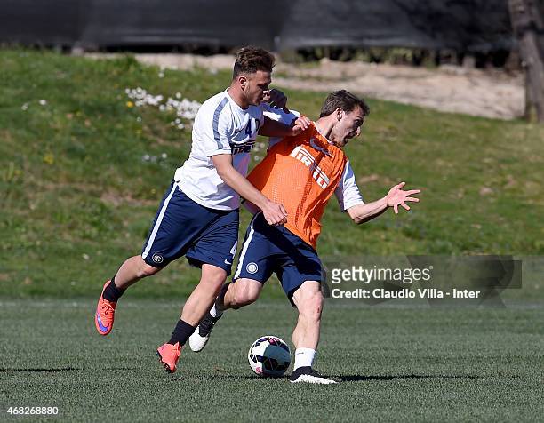Hugo Campagnaro and Federico Dimarco compete for the ball during FC Internazionale training session at the club's training ground at Appiano Gentile...