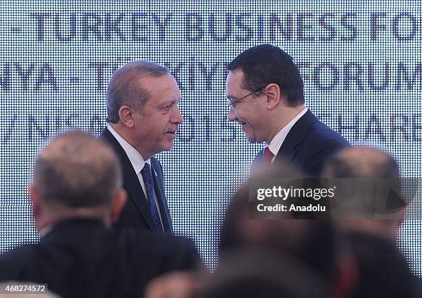 Turkish President Recep Tayyip Erdogan and Romanian Prime Minister Victor Ponta shake hands during Turkey-Romania business forum at Romania chamber...