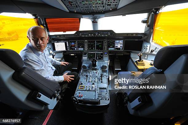 Peter Chanddler, Airbus chief test pilot engineering flight operation, sits inside the cockpit of an Airbus A350-900 during a media preview at Changi...