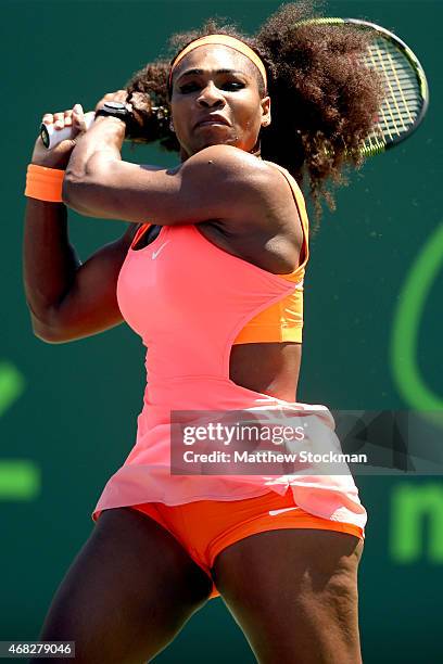 Serena Williams returns a shot to Sabine Lisiki of Germany during day 10 of the Miami Open Presented by Itau at Crandon Park Tennis Center on April...