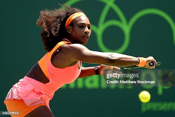 Serena Williams returns a shot to Sabine Lisiki of Germany during day 10 of the Miami Open Presented by Itau at Crandon Park Tennis Center on April...