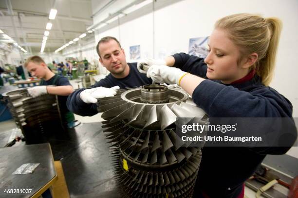 Female trainee with instrutor at the assembly of a jet engine component in the teaching workshop at MTU in Ludwigsfelde, on January 27, 2014 in...