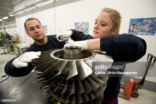 Female trainee with instrutor at the assembly of a jet engine component in the teaching workshop at MTU in Ludwigsfelde, on January 27, 2014 in...