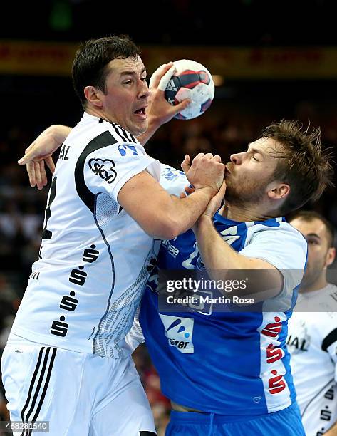 Marko Vujin of Kiel challenges for the ball with Moritz Preuss of Bergischer HC during the DKB HBL Bundesliga match between THW Kiel and Bergischer...