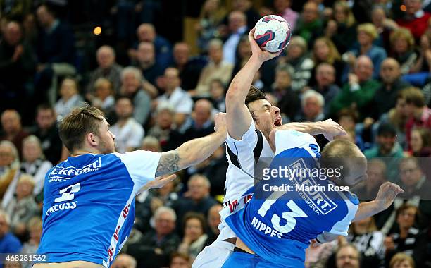 Domagoj Duvnjak of Kiel challenges for the ball with Kristian Nippes of Bergischer HC during the DKB HBL Bundesliga match between THW Kiel and...