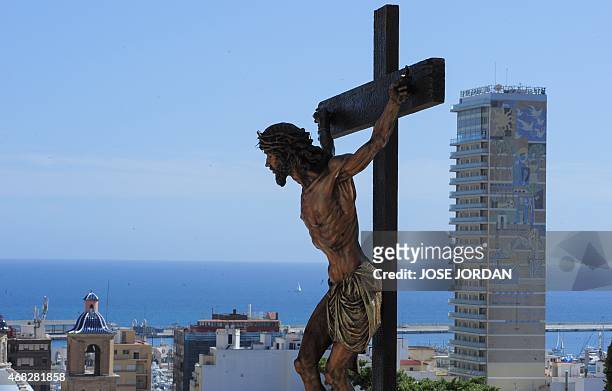An effigy of Jesus Christ on the cross is held up during the "Cristo de la Fe ", populary known as the gypsy Christ, parade during a Holy Week...