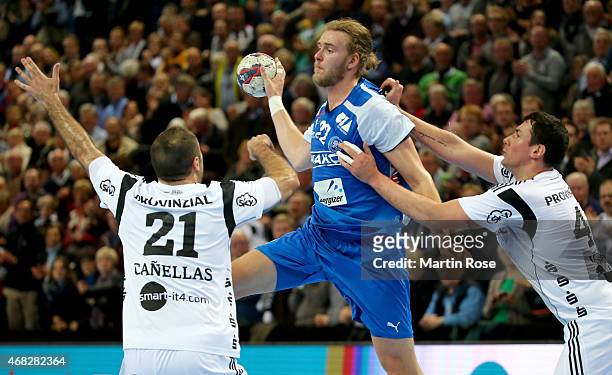 Joan Canellas of Kiel challenges for the ball with Fabian Gutbrod of Bergischer HC during the DKB HBL Bundesliga match between THW Kiel and...