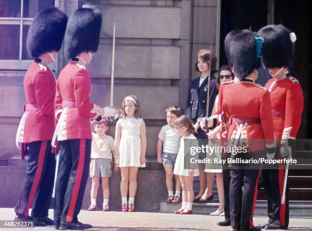 Prime position for the changing of the guard at Buckingham Palace for, left to right, John F Kennedy Junior, Caroline Kennedy, Anthony Radziwill,...