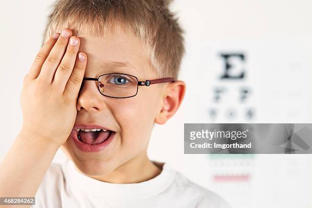 little boy having eye exam. - eye exam stockfoto's en -beelden