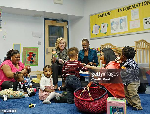 Hillary Rodham Clinton, center rear, and New York City first lady Chirlane McCray play music with children in a classroom at FirstStepNYC, an early...