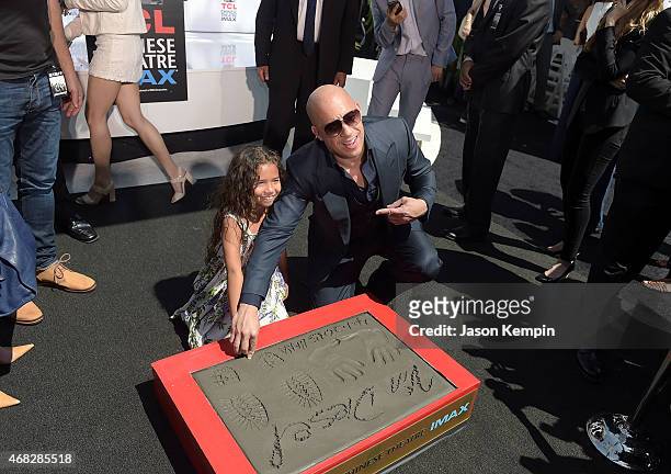 Actor Vin Diesel helps his daughter Hania Riley leave a thumbprint during Diesel's hand and footprint ceremony at TCL Chinese Theatre IMAX on April...
