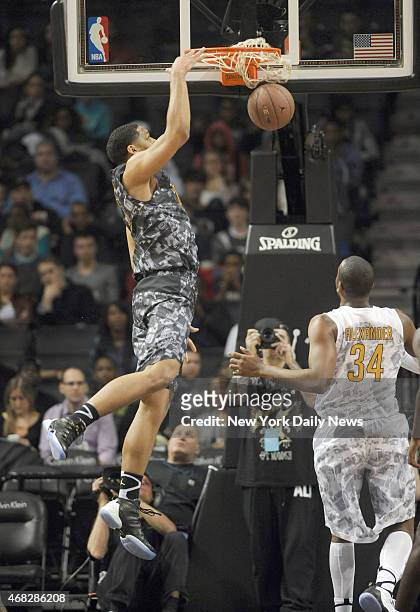 East player Jahill Okafor dunks Injured Isaiah Whitehead of Lincoln HS during game action of the 2014 Jordan Brand Classic All American game at the...