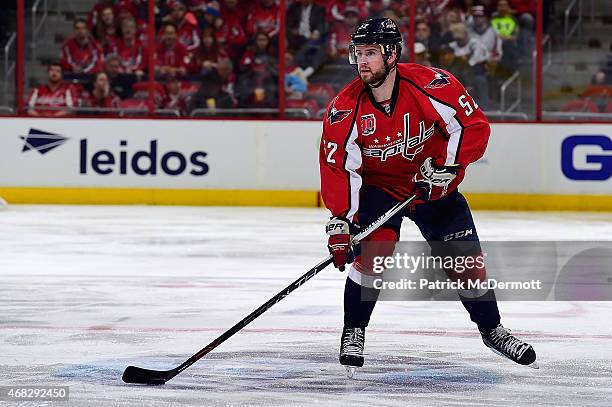 Mike Green of the Washington Capitals controls the puck in the second period against the Carolina Hurricanes during an NHL game at Verizon Center on...