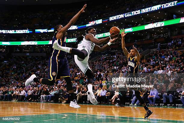 Jae Crowder of the Boston Celtics is fouled by George Hill of the Indiana Pacers with pressure from C.J. Miles during the fourth quarter at TD Garden...