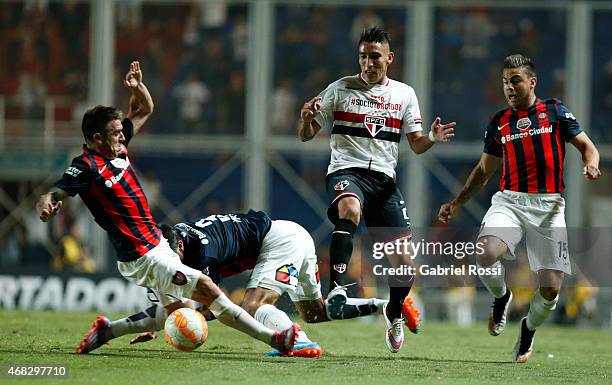 Ricky Centurion of Sao Paulo fights for the ball with Julio Buffarini of San Lorenzo during a match between San Lorenzo and Sao Paulo as part of Copa...