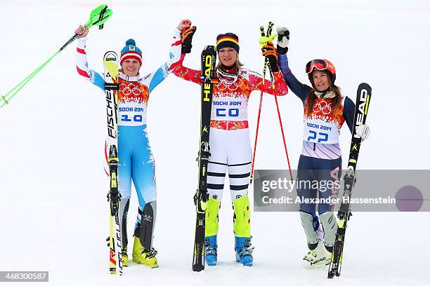 Silver medalist Nicole Hosp of Austria, gold medalist Maria Hoefl-Riesch of Germany and bronze medalist Julia Mancuso of the United States celebrate...