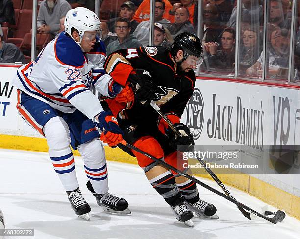 Nate Thompson of the Anaheim Ducks battles for the puck against Keith Aulie of the Edmonton Oilers on April 1, 2015 at Honda Center in Anaheim,...