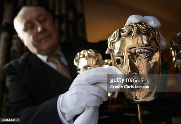 The iconic BAFTA mask awards are polished by a butler at the Savoy Hotel ahead of the British Academy Film Awards on Sunday 16th February, on...