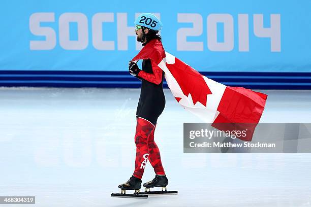 Gold medalist Charles Hamelin of Canada celebrates after wiining the Short Track Men's 1500m Final on day 3 of the Sochi 2014 Winter Olympics at...