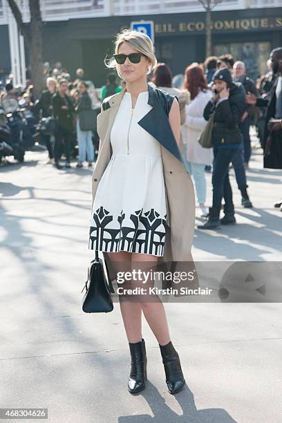 Fashion blogger Sofie Valkiers wears a Silvian Heach dress, Rayban sunglasses, Gerard Darel coat and a Delvaux bag on day 9 of Paris Collections:...