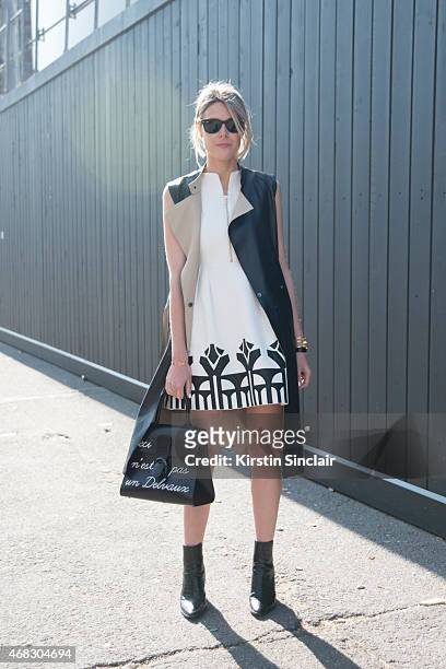 Fashion blogger Sofie Valkiers wears Silvian Heach dress, Gerard Darel coat and Delvaux bag on day 9 of Paris Collections: Women on March 11, 2015 in...