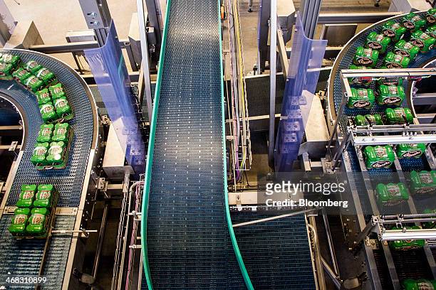 Packaged cans of Tuborg Classic beer move along the production line at the Carlsberg A/S brewery in Fredericia, Denmark, on Sunday, Feb. 9, 2014. The...